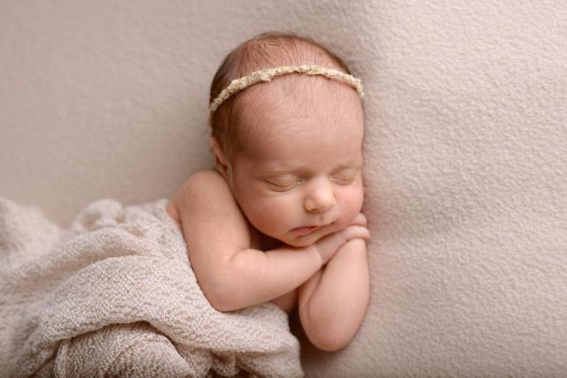 Newborn baby sleeps during the photo shoot in Cologne